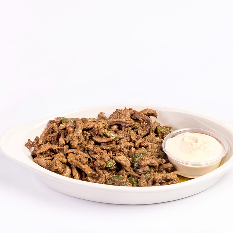 Kenz Cairo Restaurant's middle-eastern shawarma meat with green peppers and a side of creamy sauce.